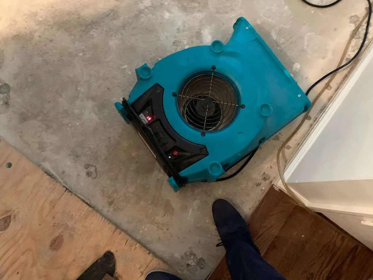 Air mover drying subfloor during Leak Detection & Repair in Devils Lake